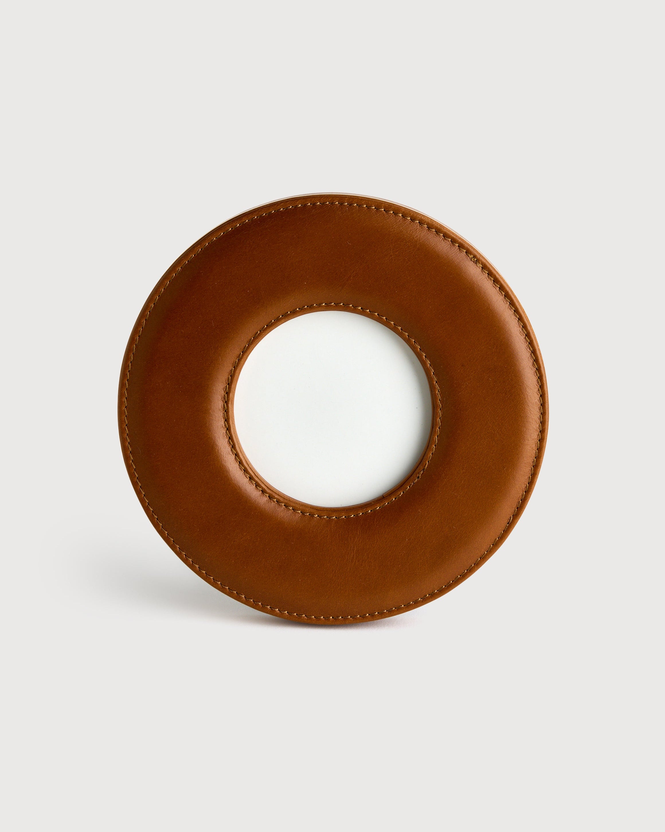 Brown leather photo frame on a light grey background