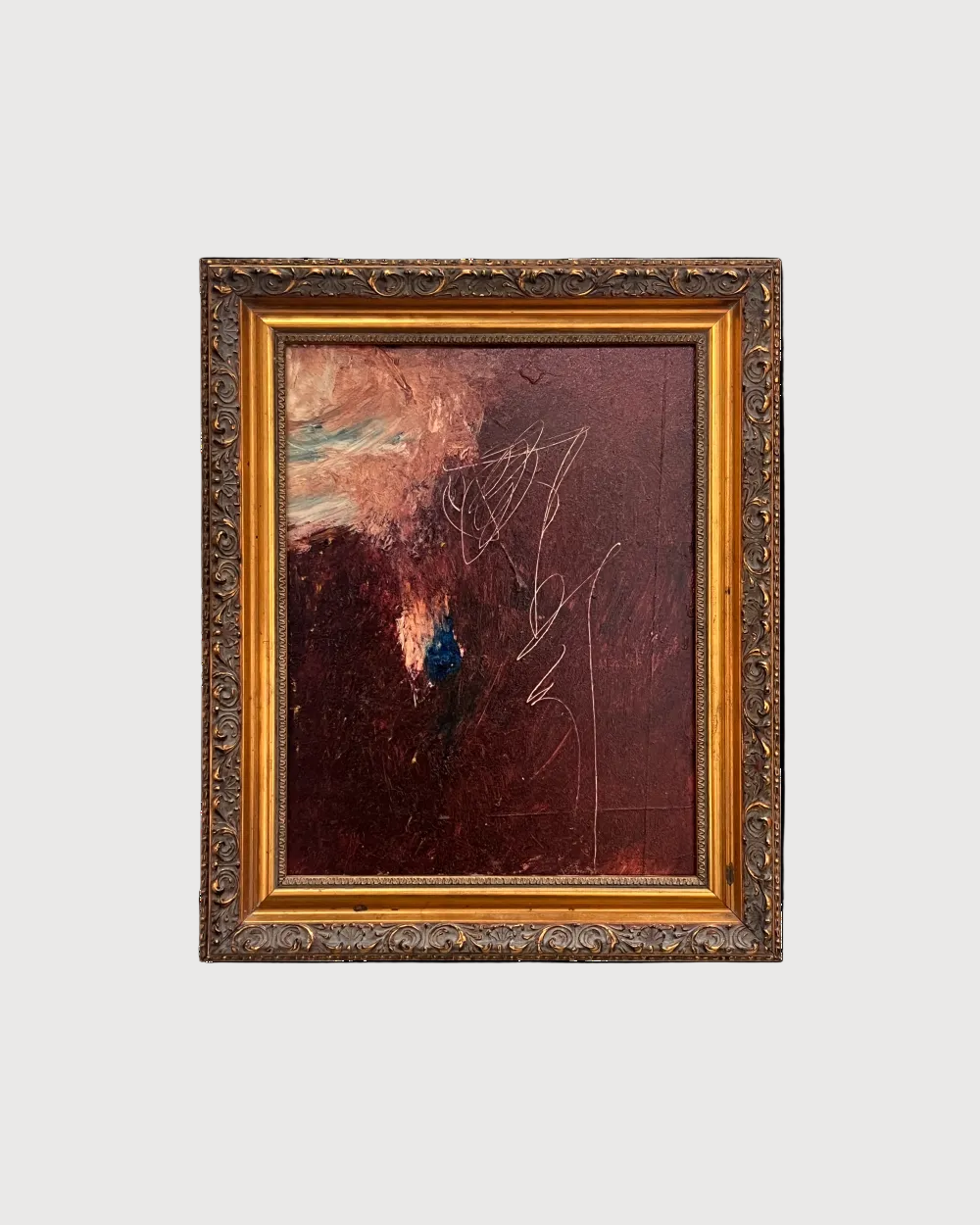 Abstract painting in a gold frame on a white background