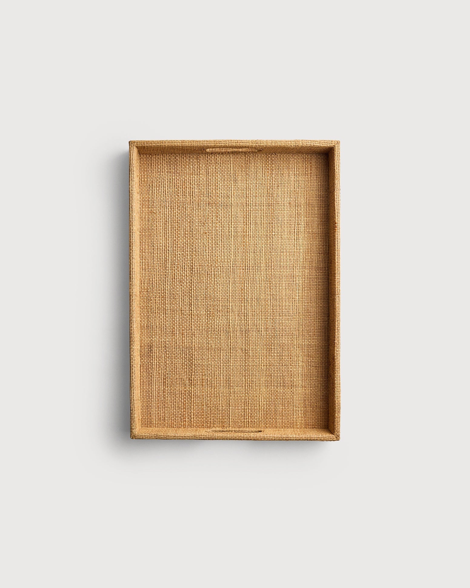 Rectangular woven tray on a light gray background