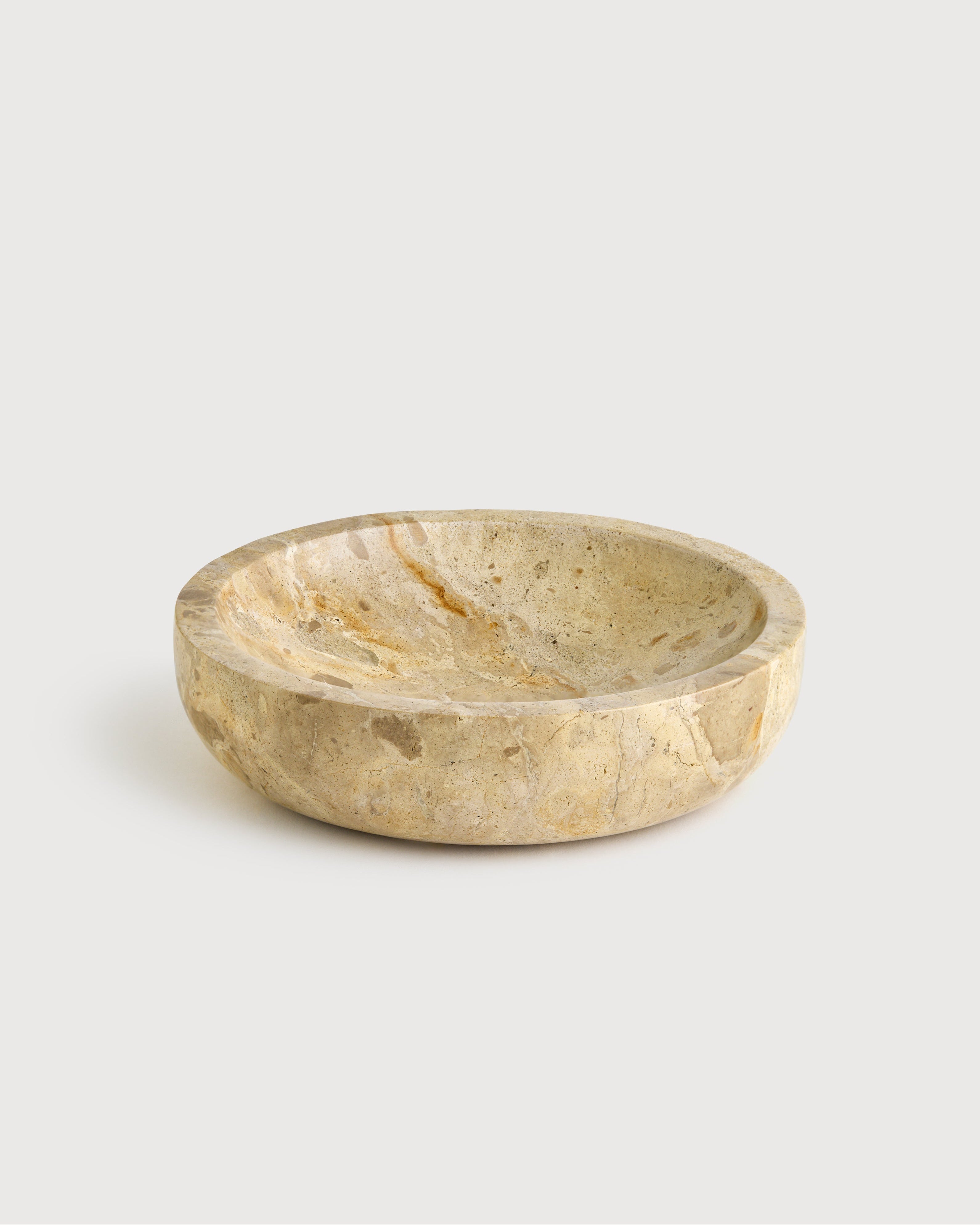 Beige marble bowl on a light gray background
