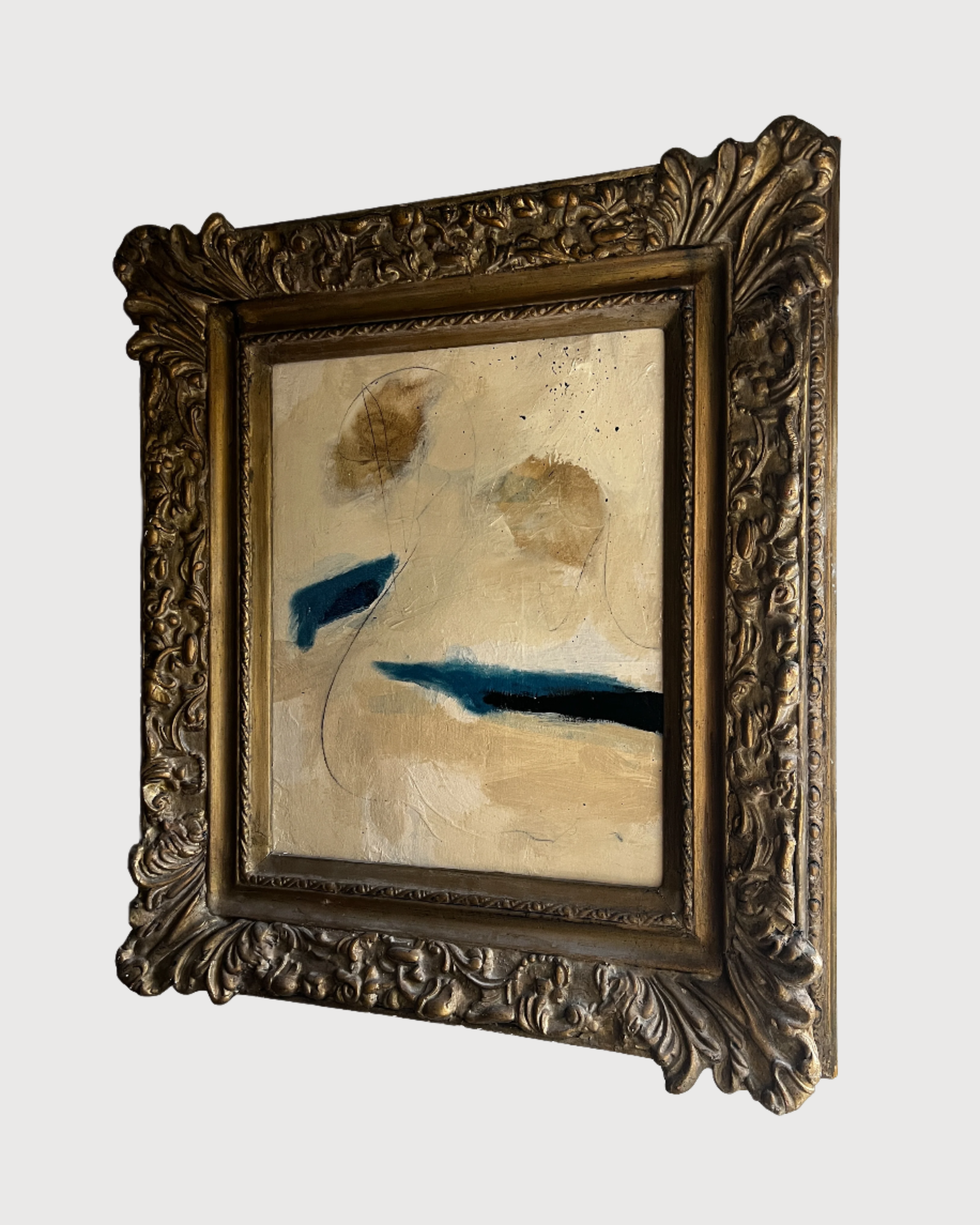 Framed abstract painting with a decorative antique gold frame on a white background
