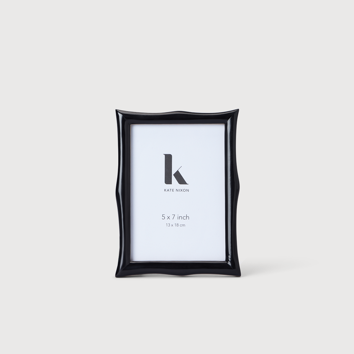 Kate Nixon Home Lyon 5x7 photo frame showing a sleek black wooden design with a glass front for display.