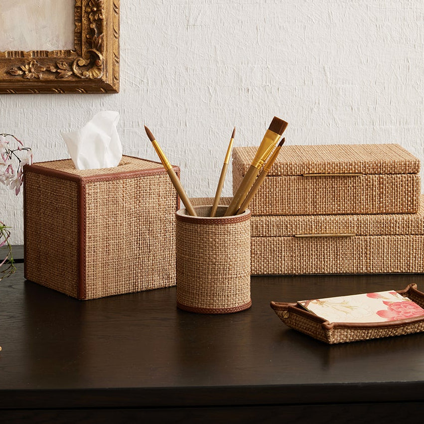 Decorative items on a wooden desk with a framed painting in the background