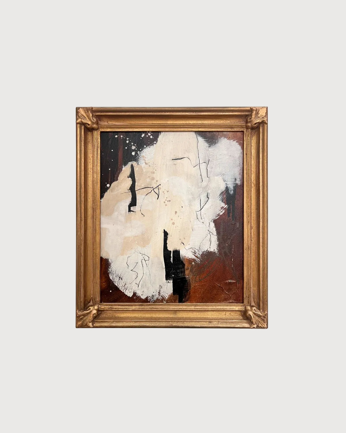 Abstract painting in a gold frame on a white background