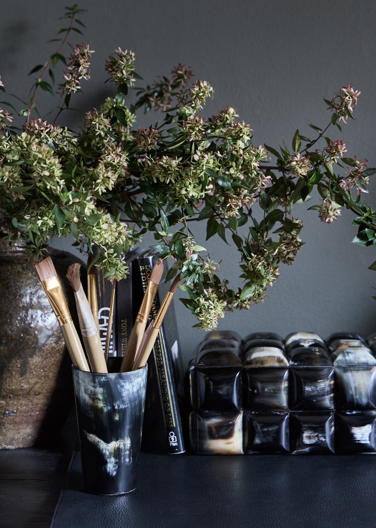 Umber horn vessel container by KATE NIXON HOME, featuring a rustic horn design with a smooth finish and natural earthy tones.
