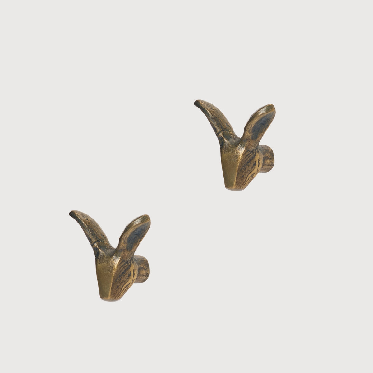 Rabbit-shaped metal hook from KATE NIXON HOME, ideal as a decorative hardware piece for hanging items.