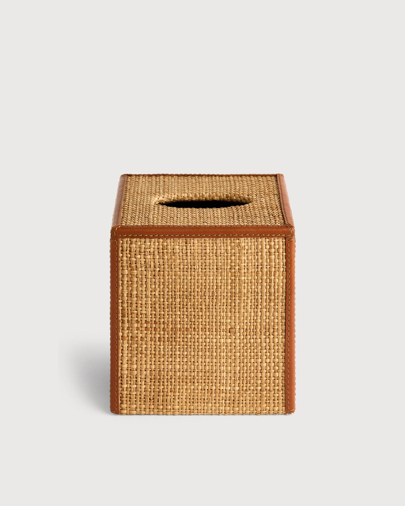 Woven tissue box cover on a light gray background