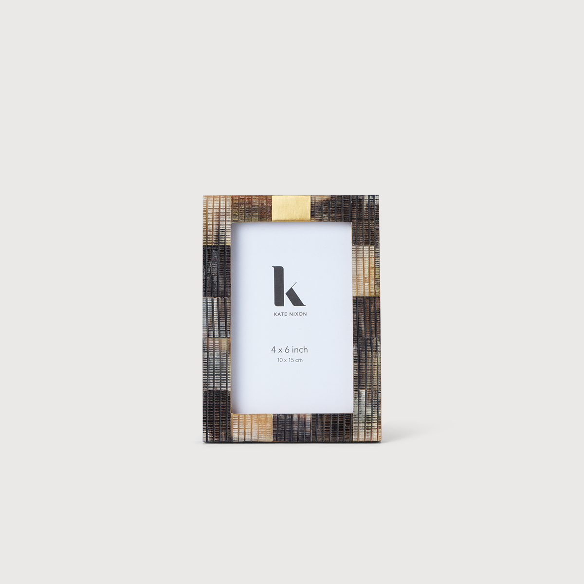KATE NIXON HOME Renn 4x6 photo frame displaying a printed photograph, made of sleek material, with a clear glass front.
