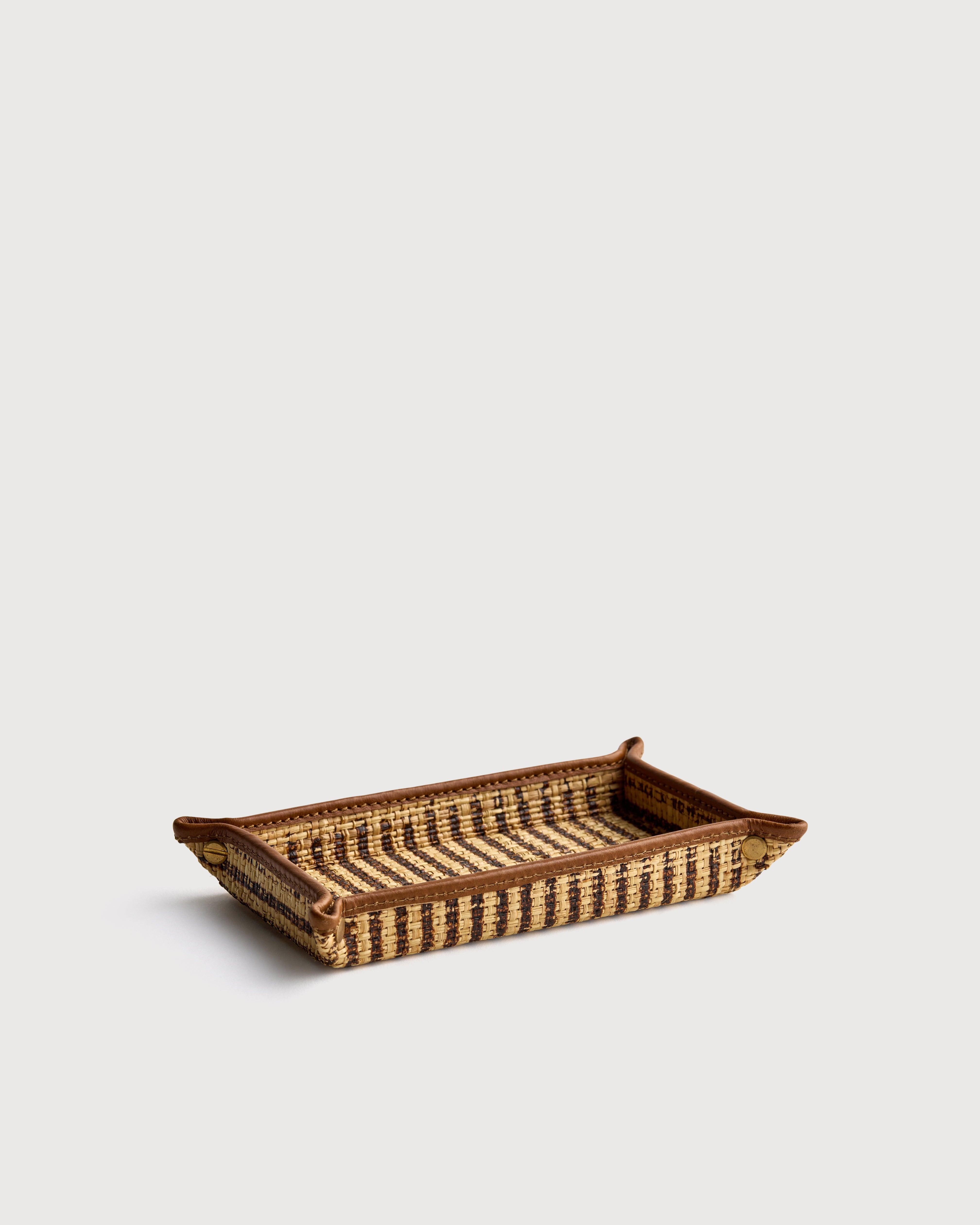 Small stripe woven rectangular tray on a light beige background