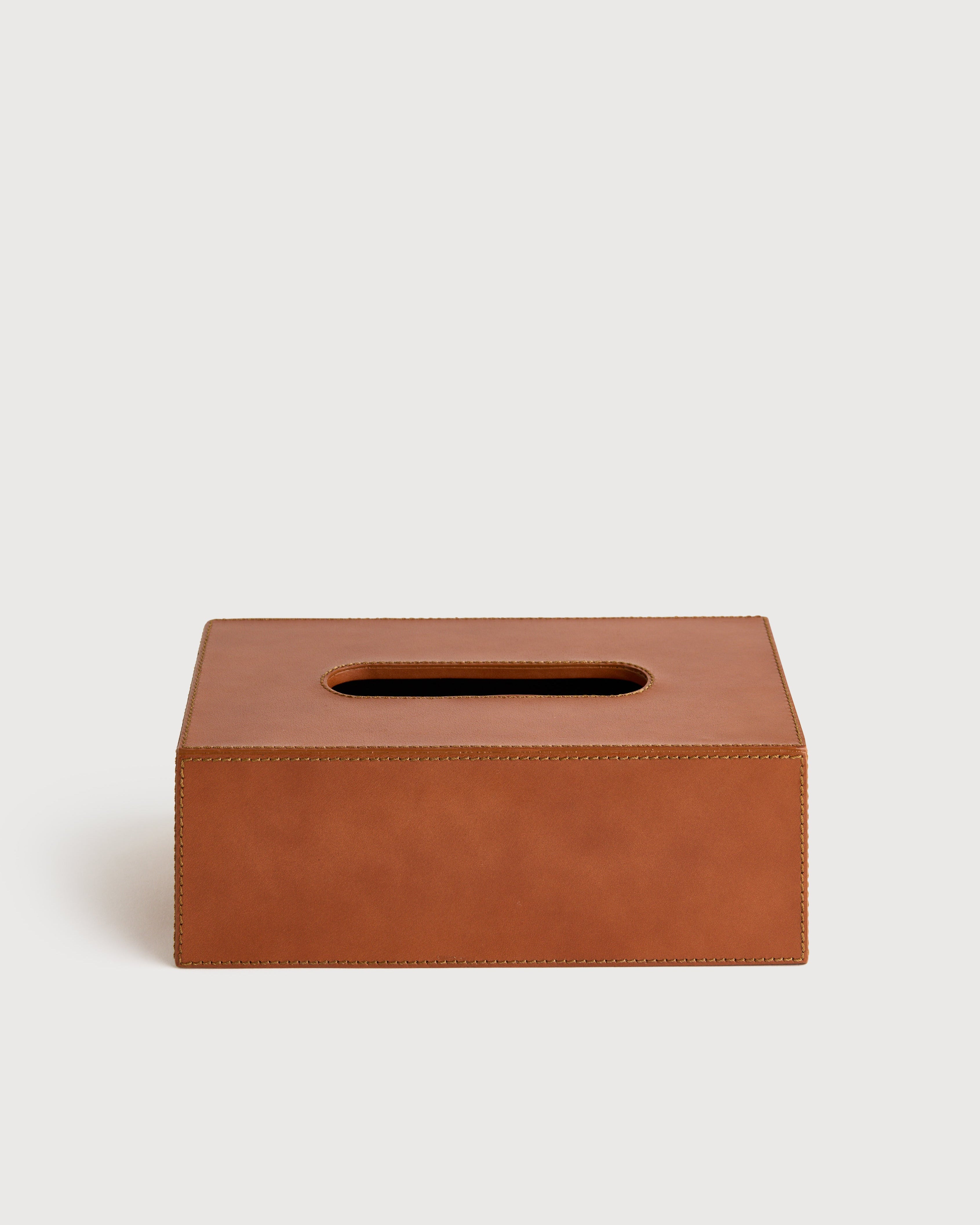 Brown leather tissue box on a light beige background